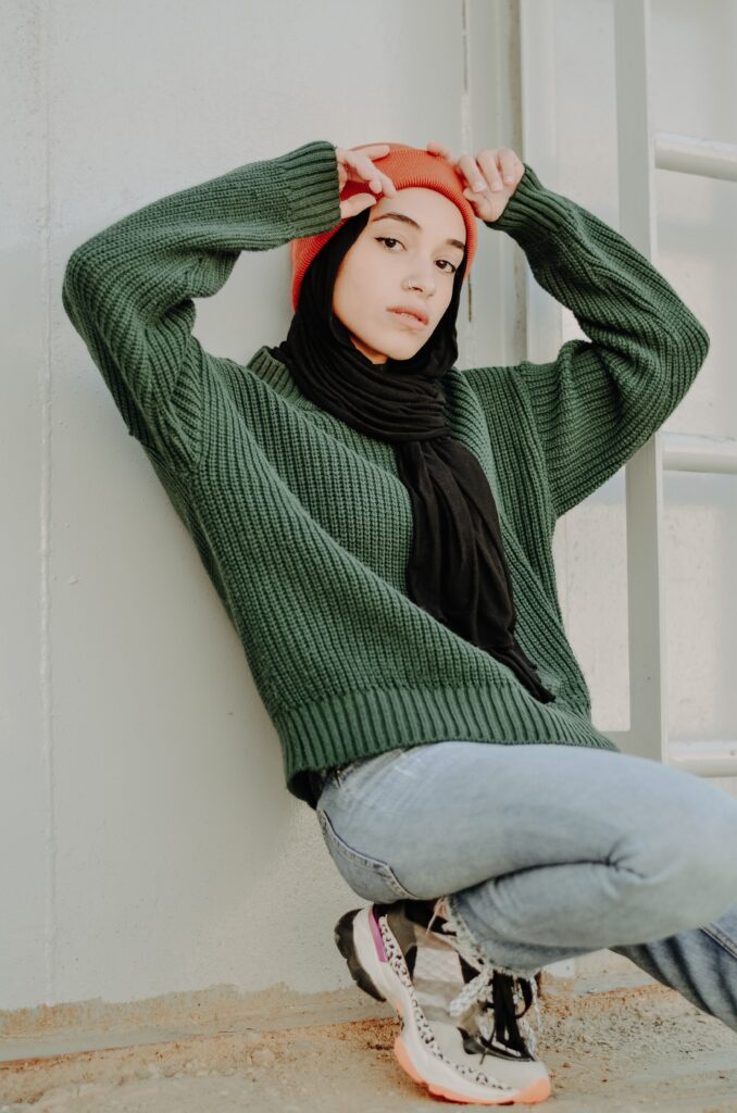 woman in green long sleeve shirt and blue denim jeans