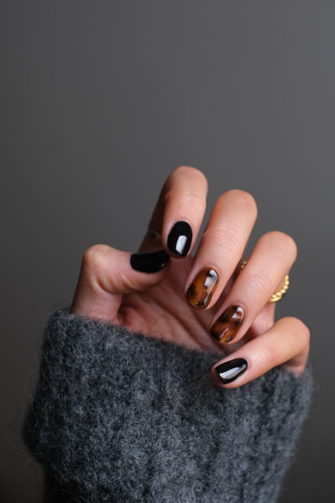 hand model wearing gold ring holding black textile