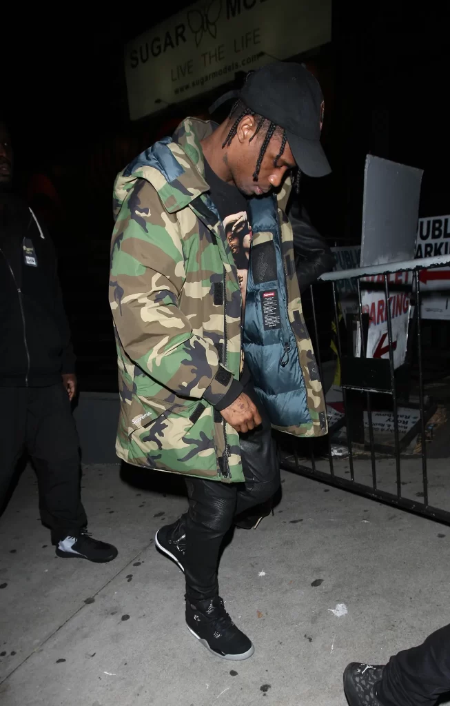 Travis Scott wearing large over-sized camo puffer coat with leather pants, Best fall and winter fashion trends for 2023