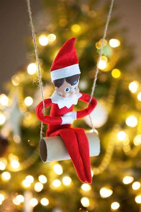 Elf swinging from a Christmas tree