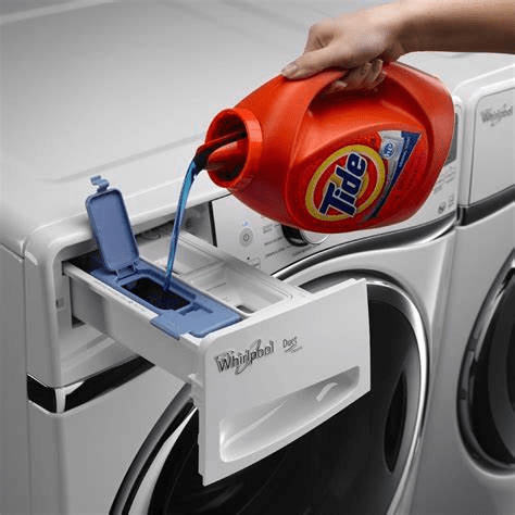 Pouring detergent into washing machine 